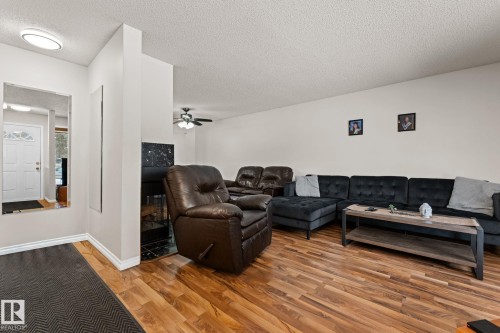 Living area featuring a textured ceiling, light wood finished floors, and ceiling fan - 36 2204 118 Street, Edmonton, AB - Indoor Photo Showing Other Room