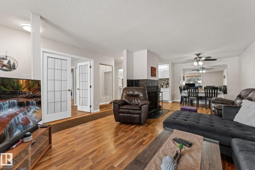 Living room with wood finished floors, ceiling fan, and a textured ceiling - 36 2204 118 Street, Edmonton, AB - Indoor Photo Showing Living Room
