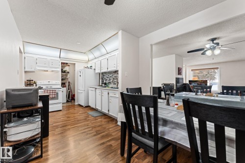 Dining area with ceiling fan, a textured ceiling, and light wood-style flooring - 36 2204 118 Street, Edmonton, AB - Indoor