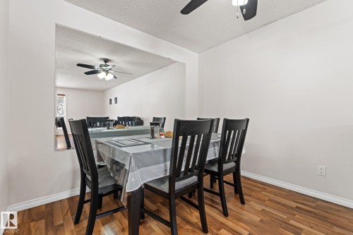 Dining room with a ceiling fan, a textured ceiling, and wood finished floors - 36 2204 118 Street, Edmonton, AB - Indoor Photo Showing Dining Room