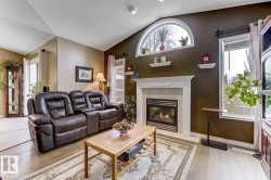 Living room featuring light wood finished floors and a tile fireplace - 