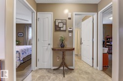 Hallway with a textured ceiling and baseboards - 