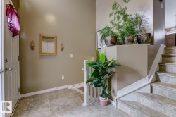Foyer featuring stairway and baseboards - 