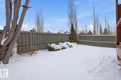 Snowy yard with a fenced backyard - 