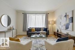 Living area with light wood-type flooring and baseboards - 