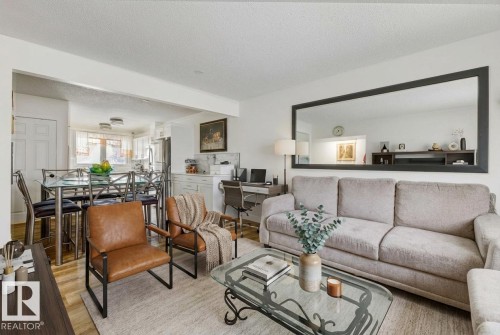 Living area featuring a textured ceiling, wood finished floors, and an office area - 13211 71 Street, Edmonton, AB - Indoor Photo Showing Living Room