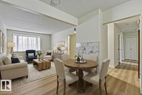 Dining area featuring a textured ceiling and light wood-type flooring - 13211 71 Street, Edmonton, AB - Indoor