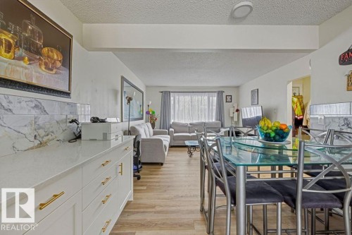 Dining area featuring light wood-style floors and a textured ceiling - 13211 71 Street, Edmonton, AB - Indoor Photo Showing Dining Room