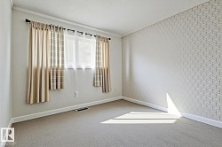 Carpeted empty room with baseboards and a textured ceiling - 
