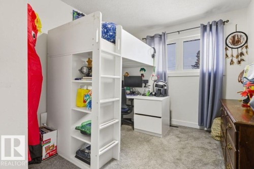 Bedroom featuring light colored carpet, a desk, and a textured ceiling - 13211 71 Street, Edmonton, AB - Indoor