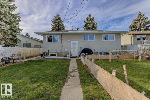 Rear view of property featuring a fenced backyard and stucco siding - 13211 71 Street, Edmonton, AB - Outdoor