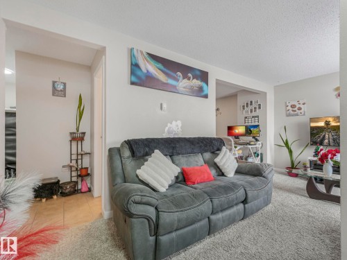 Carpeted living room featuring a textured ceiling - 13271 47 Street, Edmonton, AB - Indoor Photo Showing Living Room