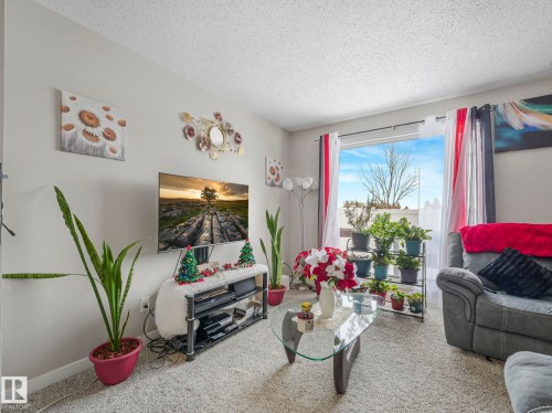 Carpeted living area with a textured ceiling - 13271 47 Street, Edmonton, AB - Indoor Photo Showing Living Room