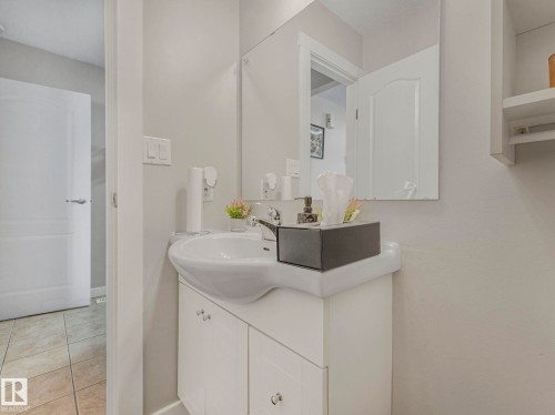 Bathroom featuring vanity and light tile patterned flooring - 13271 47 Street, Edmonton, AB - Indoor Photo Showing Bathroom