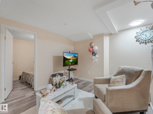 Living area featuring wood finished floors and baseboards - 13271 47 Street, Edmonton, AB - Indoor