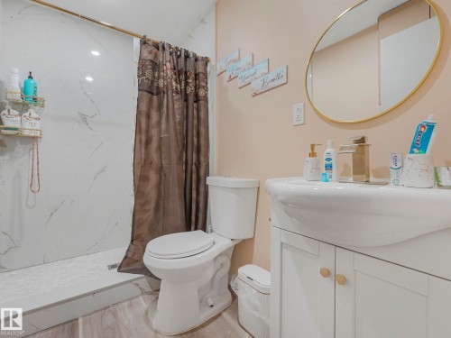 Bathroom featuring vanity and a marble finish shower - 13271 47 Street, Edmonton, AB - Indoor Photo Showing Bathroom