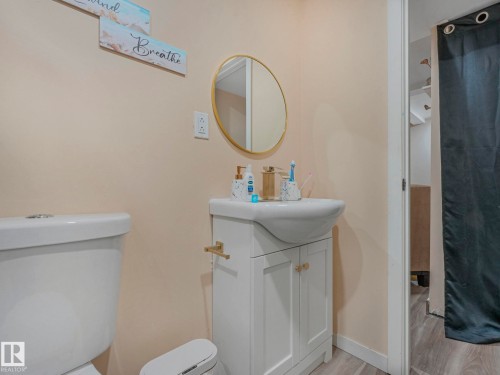Full bathroom featuring vanity, curtained shower, and light wood-style flooring - 13271 47 Street, Edmonton, AB - Indoor Photo Showing Bathroom