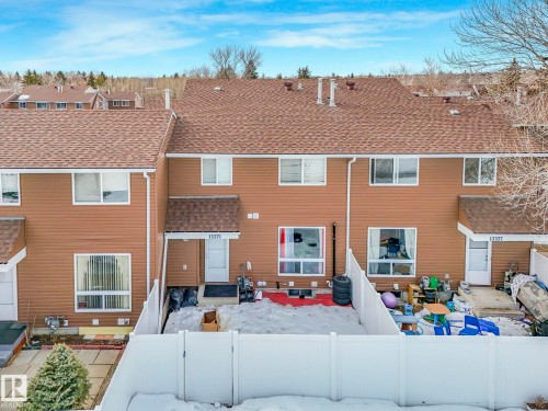 Back of house featuring a shingled roof, a patio, a fenced backyard, and a gate - 13271 47 Street, Edmonton, AB - Outdoor