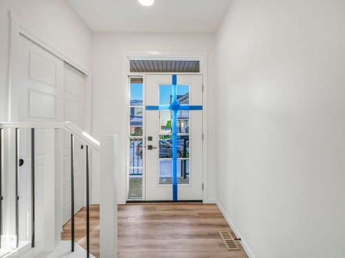 Entryway featuring wood finished floors and baseboards - 20506 16A Avenue, Edmonton, AB - Indoor Photo Showing Other Room