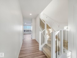 Staircase with wood finished floors and recessed lighting - 