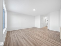 Unfurnished room with light wood-style flooring and baseboards - 