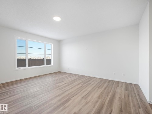 Spare room featuring baseboards and light wood finished floors - 20506 16A Avenue, Edmonton, AB - Indoor Photo Showing Other Room
