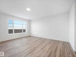 Spare room featuring baseboards and light wood finished floors - 