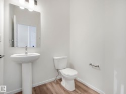 Bathroom featuring toilet and wood finished floors - 