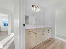 Bathroom with vanity and light wood-style floors - 