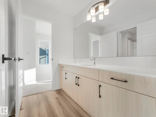 Bathroom featuring light wood finished floors and vanity - 20506 16A Avenue, Edmonton, AB - Indoor Photo Showing Bathroom