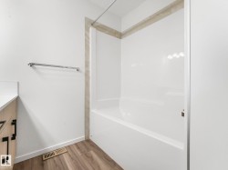 Full bathroom with vanity, light wood-type flooring, and tub / shower combination - 
