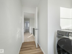 Laundry area featuring washer / dryer and light wood-type flooring - 