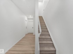 Stairs with wood finished floors and recessed lighting - 