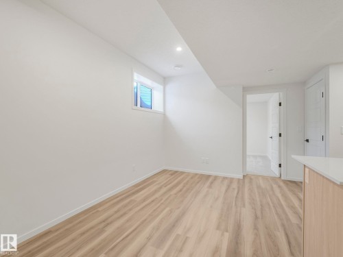 Empty room with light wood-type flooring and recessed lighting - 20506 16A Avenue, Edmonton, AB - Indoor Photo Showing Other Room