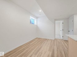 Empty room with light wood-type flooring and recessed lighting - 