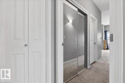 Hallway with carpet floors and a textured ceiling - 