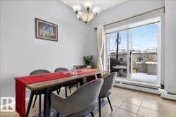 Dining area with hanging lights, baseboard heating, and light tile patterned flooring - 