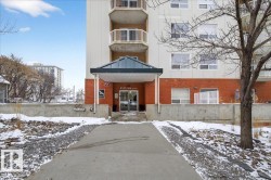 Snow covered property featuring a view of apartment building / complex - 