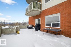 Yard layered in snow with a balcony - 