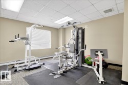 Exercise room with a paneled ceiling and a baseboard radiator - 