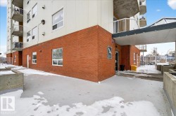 View of side of home featuring a balcony and brick siding - 