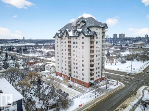 Snow covered building featuring a view of apartment building / complex and a view of city - 105 9707 105 Street, Edmonton, AB - Outdoor