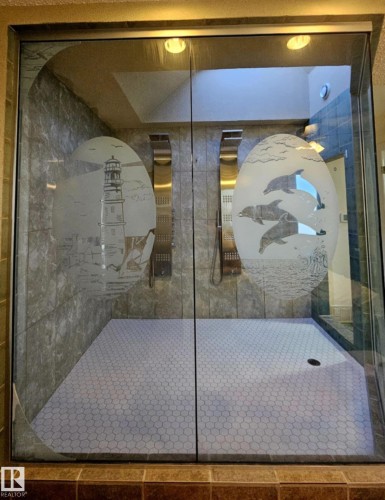 Full ensuite with a  2 shower stall, new tiled floor and etched glass walls, plus sky light - 8512 131 Avenue, Edmonton, AB - Indoor