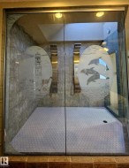 Full ensuite with a  2 shower stall, new tiled floor and etched glass walls, plus sky light - 