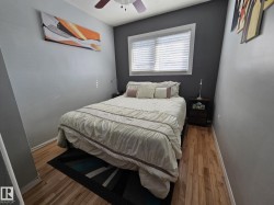 Bedroom featuring hardwood / wood-style flooring and ceiling fan - 
