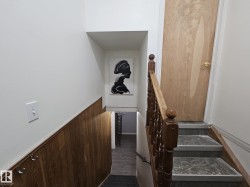 Stairway featuring a wainscoted wall, wooden walls, Seperate entrance for non permitted suite - 