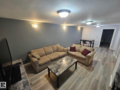 Living room featuring wood finished floors and baseboards - 8512 131 Avenue, Edmonton, AB - Indoor Photo Showing Living Room