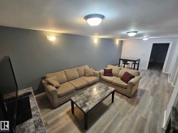 Living room featuring wood finished floors and baseboards - 