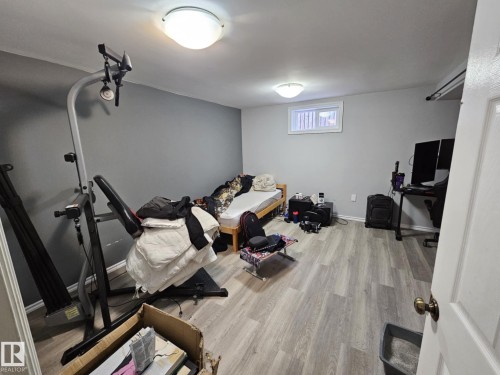 Exercise room with light wood-type flooring and baseboards - 8512 131 Avenue, Edmonton, AB - Indoor