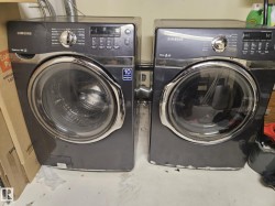 Laundry area featuring washing machine and clothes dryer - 